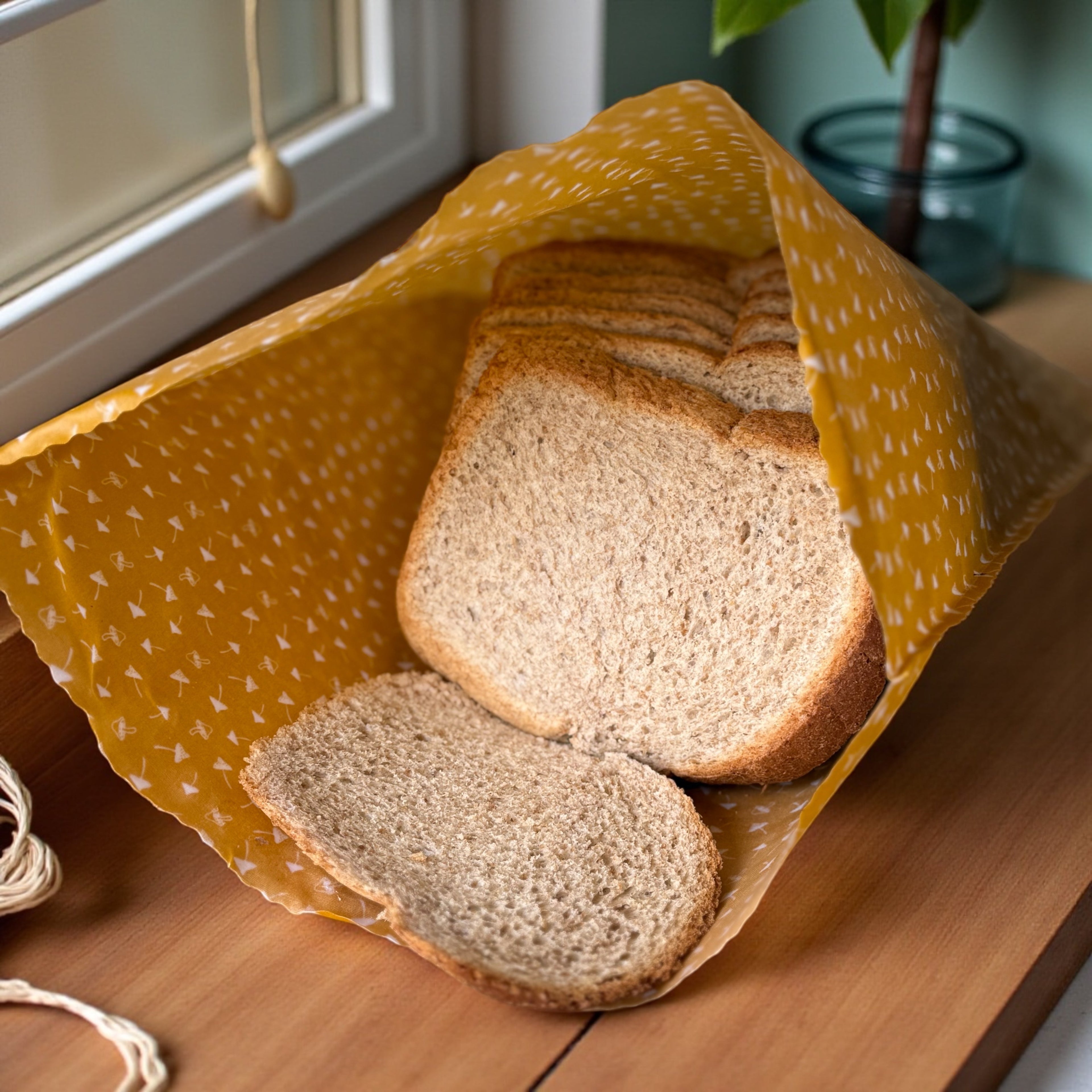 Sliced bread on a yellow cloth on a wooden surface